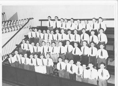 (5th or 6th, probably the latter) in Joey's primary school when we competed in the Feis Ceoil, held in the Metropolitan ​Hall, Abbey Street. We sang 'Go thoughts on Golden Wings', (real name 'Va Pensiero' form the opera Nabucco) as directed by Bro. Johnston. Back row, right-hand corner: Joe Gantly, below him is Dermot Carolan and on his right is Jim Cummins who is an architect ; Matt O'Donoghue is in the second row, 8th from the left and directly above him in the third row is John Teeling. Photo provided by Joe Gantly.