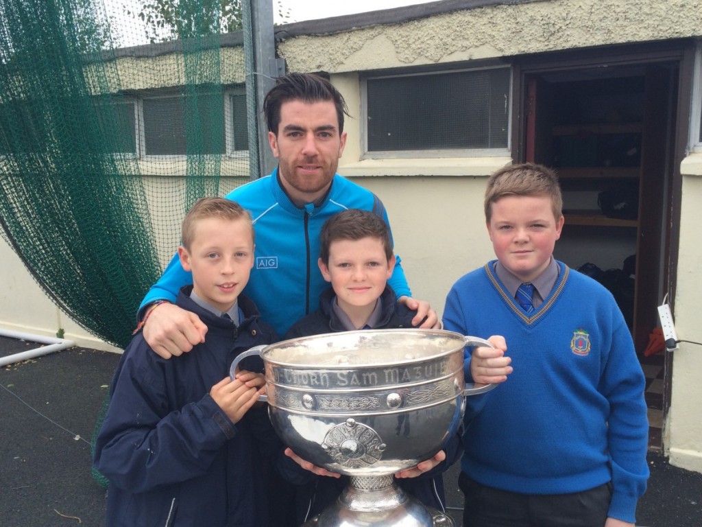 Michale Darragh MacAuley with the Sam Maguire cup and first years Evan White, Oran Burke and Darragh Hendrick